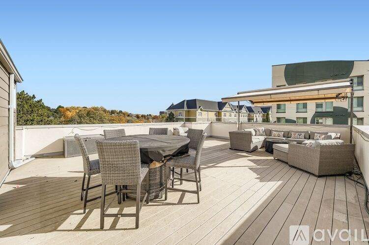 A wooden deck with a table and chairs is available for rent.