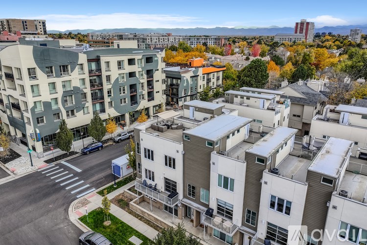A cityscape with buildings and a road in the foreground.