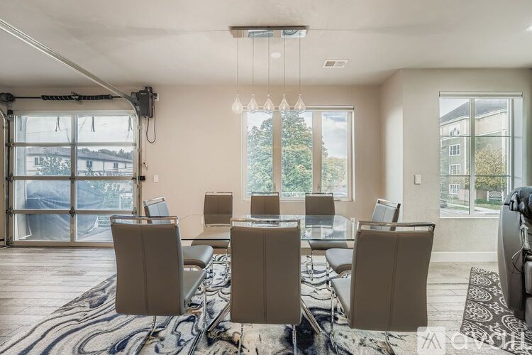 A modern dining room with a glass table and chairs.