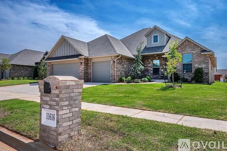 A house with a stone pillar in front that says 11616.