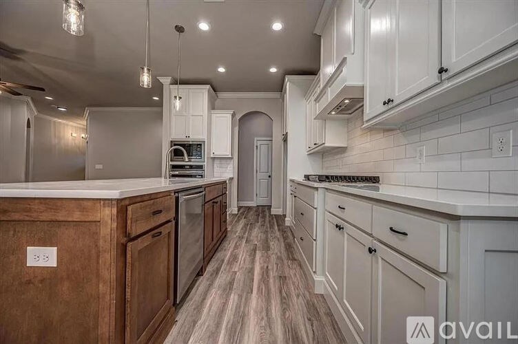 A modern kitchen with wooden cabinets and a central island.