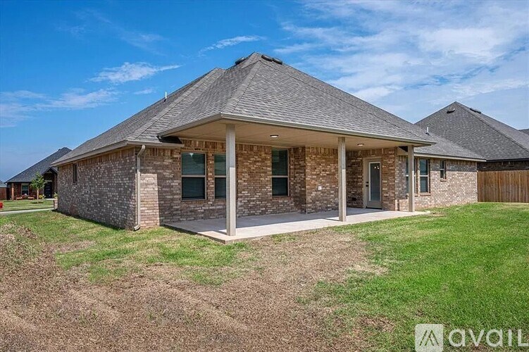 A house with a grey roof and a brick exterior is available for purchase.