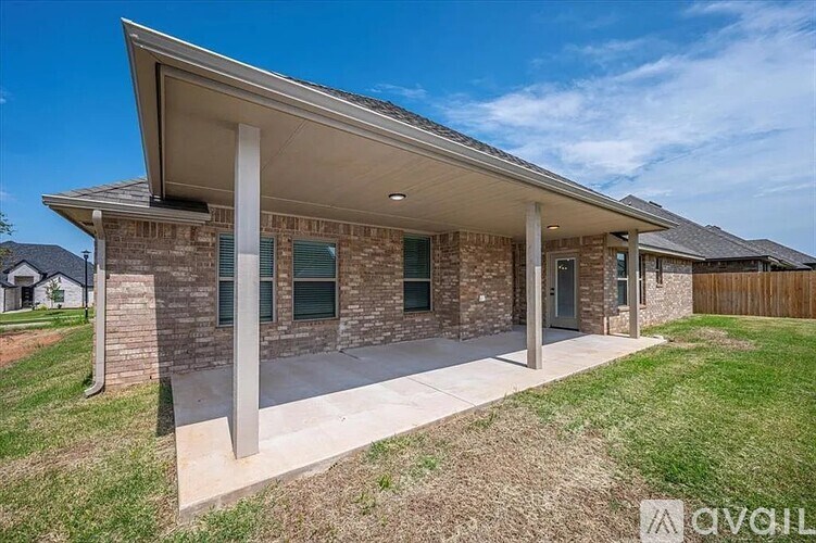 A house with a covered porch and a brick facade is for sale.