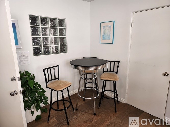 A small table with two chairs in a room.