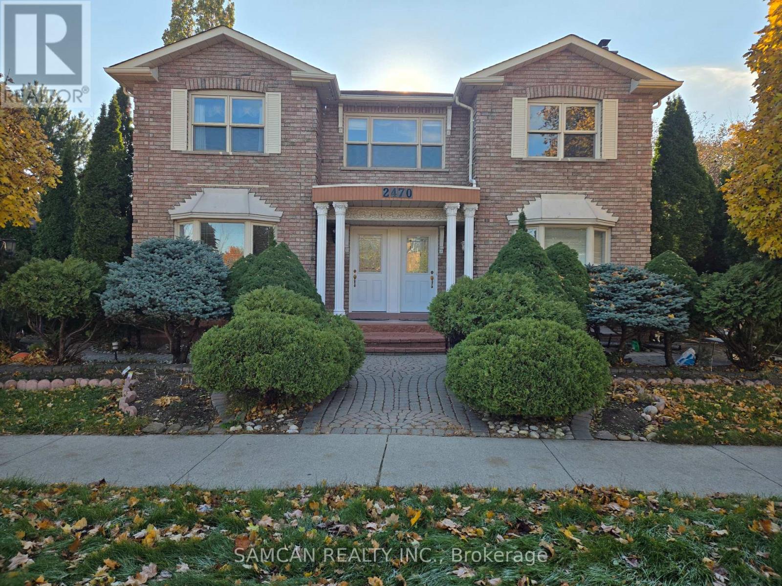 A house with a driveway and garage doors.