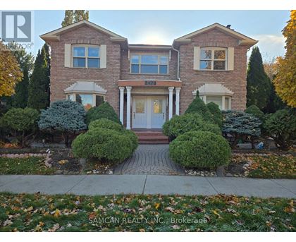 A house with a driveway and garage doors.