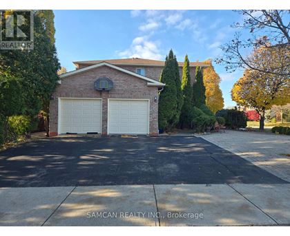 A house with a front yard and bushes.