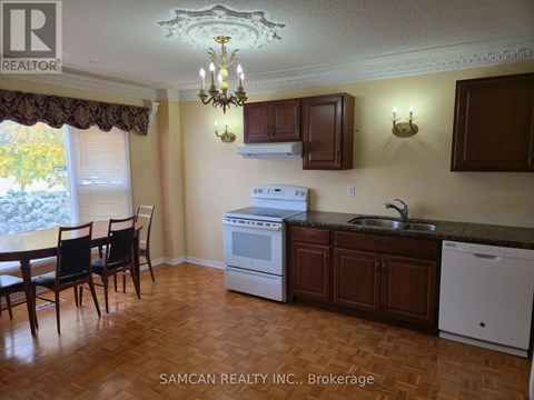 A kitchen with a table and chairs in front of a window.