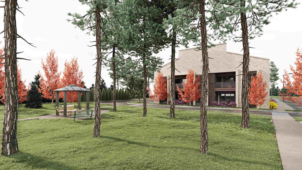 A building is surrounded by trees with red leaves.