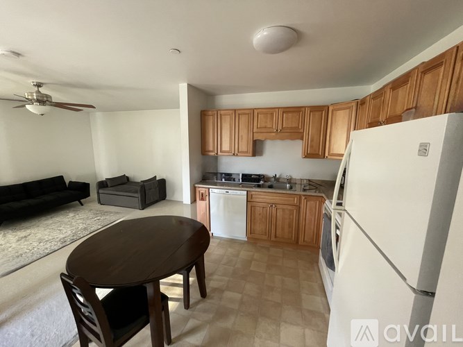 A kitchen with a table and chairs in the middle of the room.