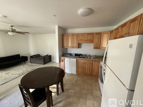 A kitchen with a table and chairs in the middle of the room.