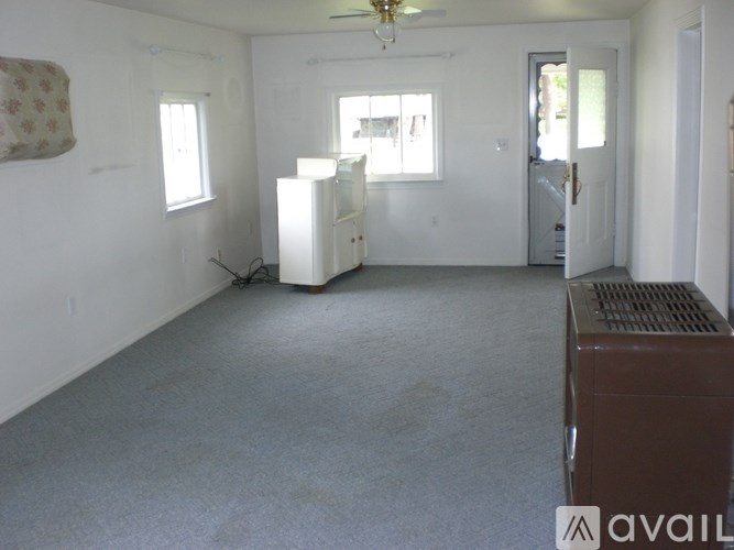 A room with a brown appliance and a white refrigerator.