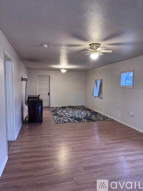 A room with a brown appliance and a white refrigerator.