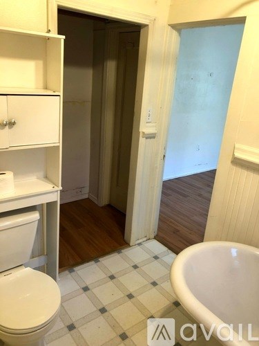 A bathroom with a toilet, tub and sink.