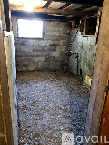 A room with a concrete wall and a window.