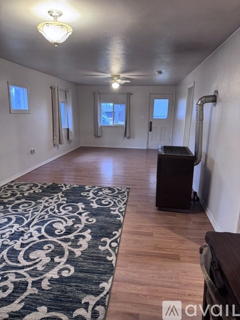 A room with wooden floors and a ceiling fan.