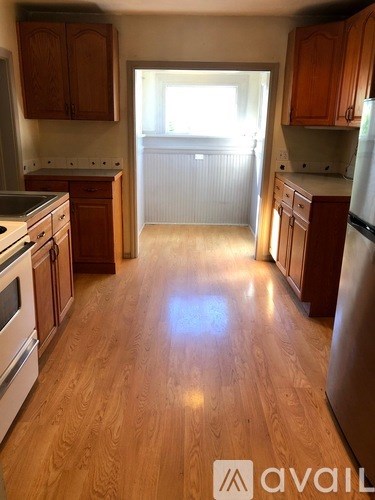 A kitchen with wooden floors and appliances.