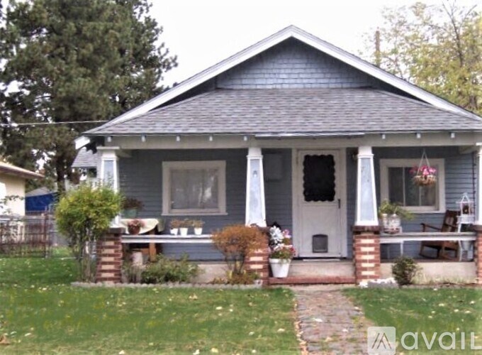 A small house with a front porch and a white door.