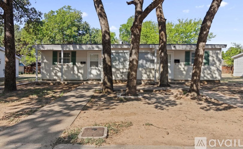 A house with a tree in front of it.