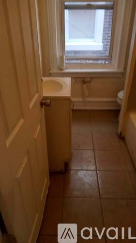 A bathroom with a toilet and a window.