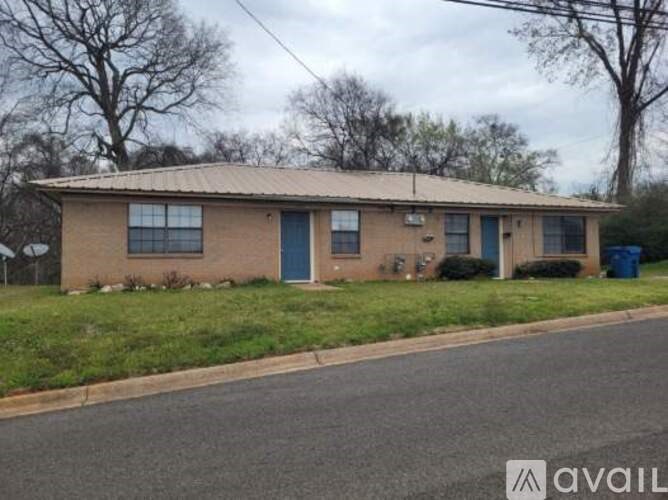 A house with a blue door is for sale.