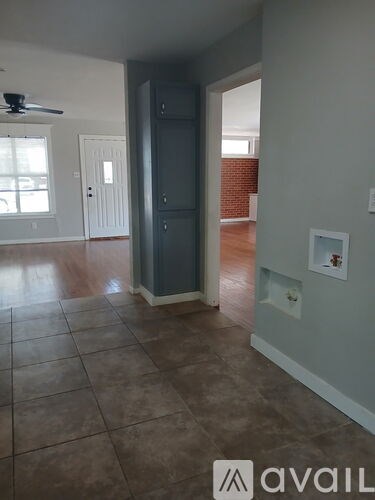 A room with a tiled floor and a ceiling fan.