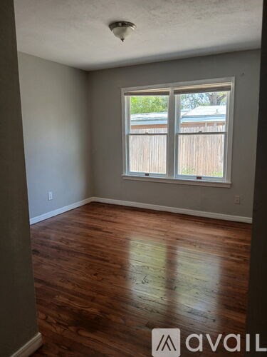 A room with wooden floors and a window.