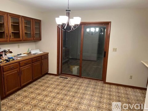 A kitchen with wooden cabinets and a patterned floor.
