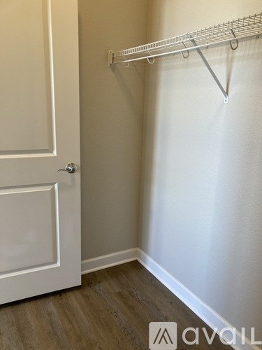 A white door is on the left and a white shelf is on the right.