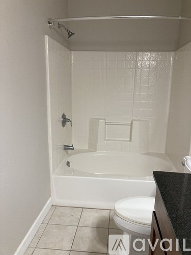 A white bathroom with a toilet and a bathtub.