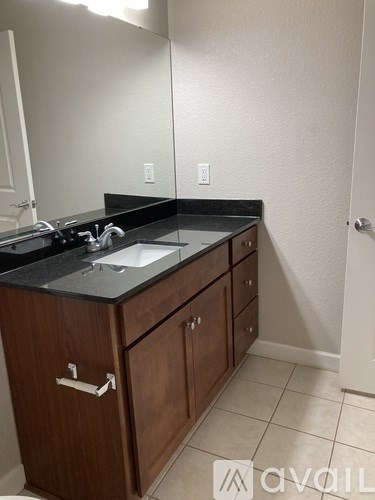 A bathroom with a sink and a mirror.