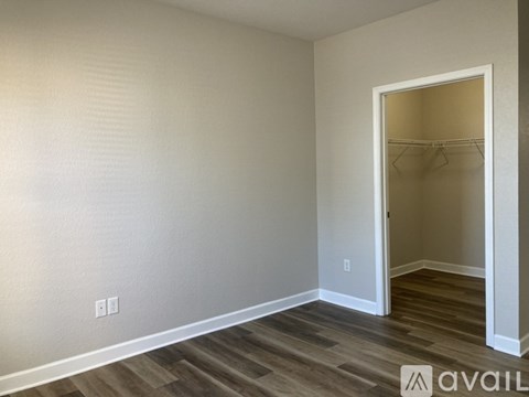 A room with a wooden floor and a white door.