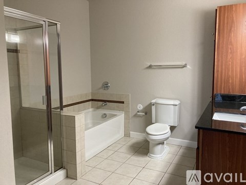 A bathroom with a toilet, sink, and shower.