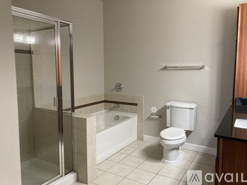 A bathroom with a toilet, tub, and shower.