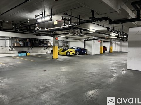 A yellow car is parked in a large, empty garage.