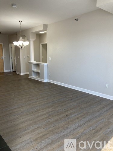 A room with wooden floors and a chandelier.