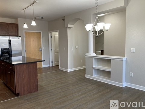 A kitchen with a wooden island and a white fridge.