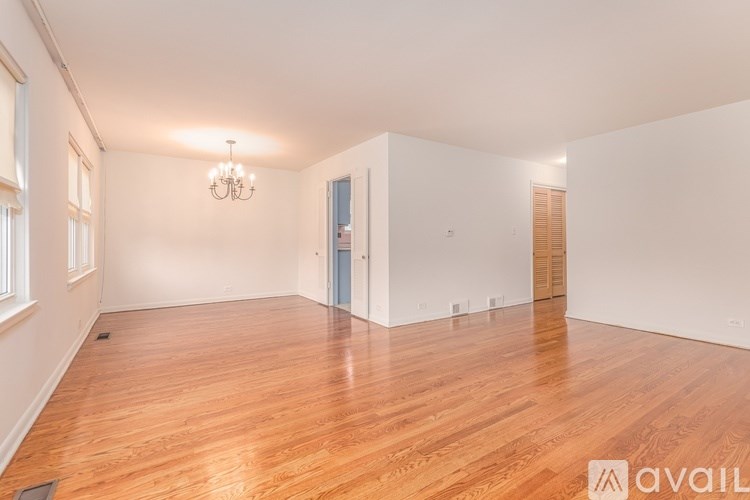 A room with wooden floors and a chandelier.