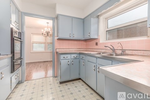 A kitchen with a tile floor and a sink.
