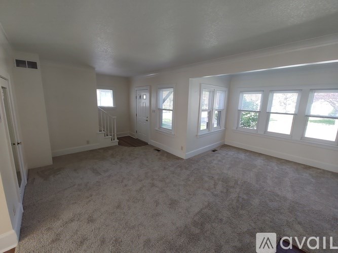 A room with carpeted floor and white walls.