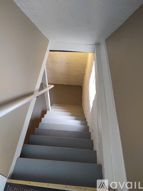 A staircase with a light on the side.