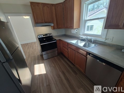 A kitchen with wooden cabinets and stainless steel appliances.