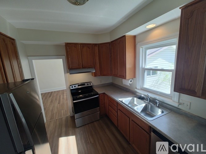 A kitchen with wooden cabinets and stainless steel appliances.