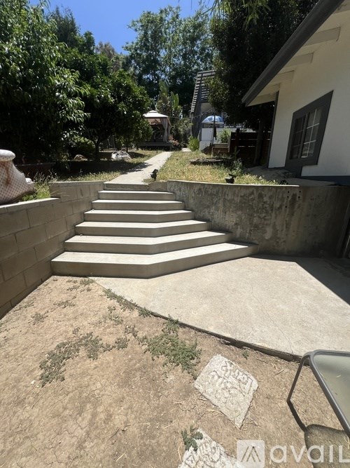 A concrete staircase leads up to a house.