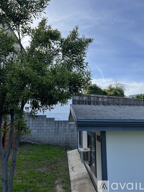 A house with a tree in front of it.