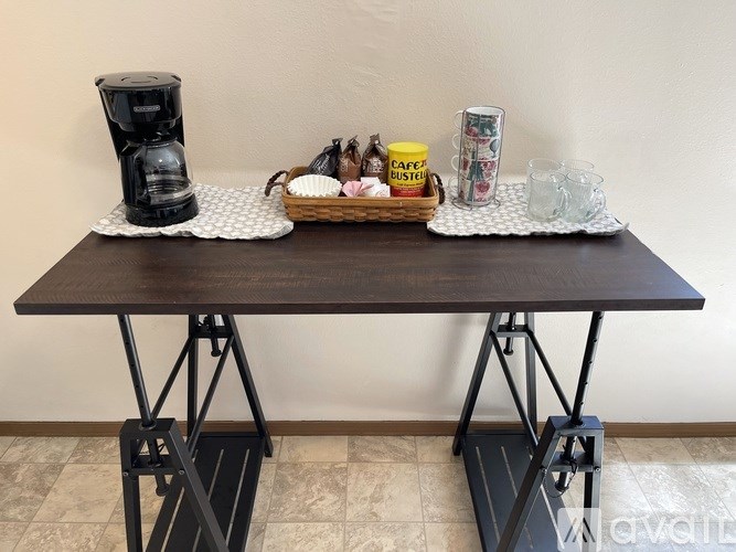 A coffee table with a coffee maker on it.