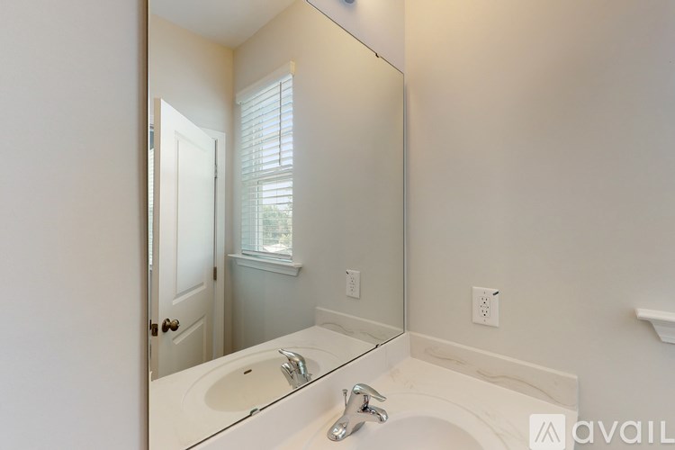 A bathroom with a sink and a mirror.