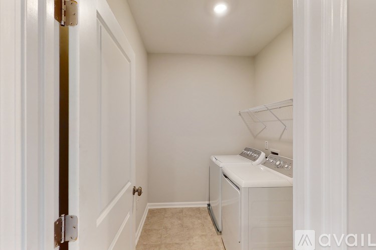 A small laundry room with a washer and dryer.
