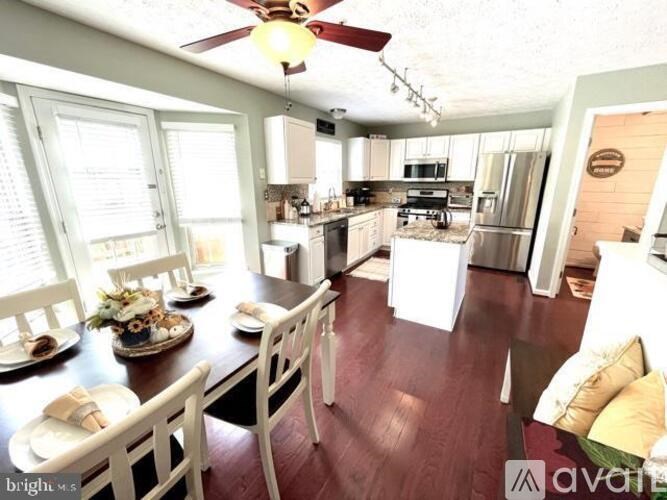 A kitchen with a table set for a meal.