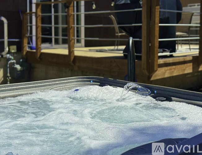 A hot tub with water being poured into it.